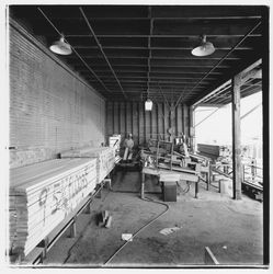 Workers assembling stacks of 2" x 6" floor lumber at Speedspace Corporation, 920 Shiloh Road, Windsor, California, 1971