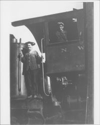 Railroad workers standing on a Northwest Pacific engine, Petaluma?, California, about 1914