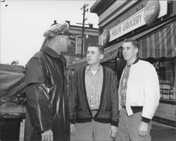 Policeman and two boys in front of Volpi Grocery, Petaluma, California, about 1956