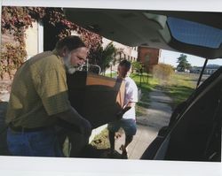 John Agnew and Hal Janssen moving a piece of machinery out of the Sunset Line & Twine Company in Petaluma, California, into a vehicle on Dec. 5, 2006