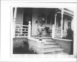 Tom Agius standing on the porch of 210 West Street, Petaluma, California, about 1926