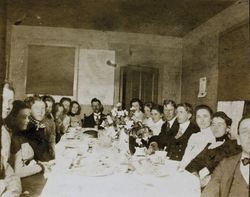 Sarah Jane Walsh seated at a table with the Charles Waddell family in their home on Douglas Street, Petaluma, California, about 1894