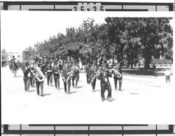 Charlie Chaplin impersonator leading a band in a Butter and Eggs Day Parade, Petaluma, California, about 1923