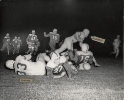 Run play during Petaluma Leghorn game against Crockett