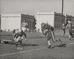 Run play during Petaluma Leghorns game against San Diego