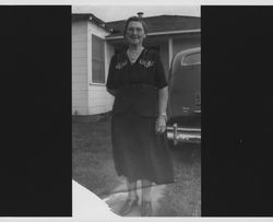 Emma Brush standing in a driveway, Petaluma, California, about 1940