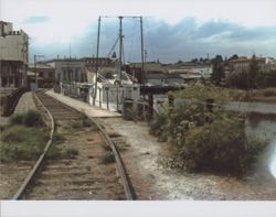 View of Water Street and the Petaluma & Santa Rosa Railroad trestle and tracks, Water Street, Petaluma, California, between 1977 and 1986