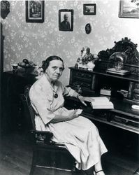 Elizabeth Waters Burbank seated at her desk