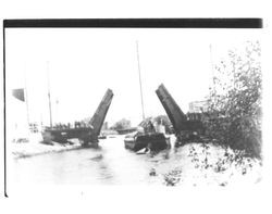 Tug towing a barge under the D Street drawbridge, Petaluma, California, about 1925