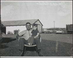 Jack W. Dei holding a boy, 831 High School Road, Sebastopol, California about 1950