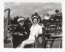 Miss Sonoma County, Sandra Duden, and Santa Rosa Fire Chief George H. Magee in the Santa Rosa 20-30 Club's old fire engine, "Engine Co. no. 50," Santa Rosa, California, 1958