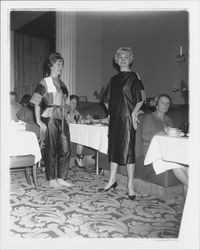 Models in evening wear with geometric patterns and Topaz Room customers in the "Dramatic Moods" fashion show in the Topaz Room, Santa Rosa, California, 1959