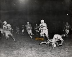 Run play during Petaluma Leghorn game against Oakland Gaels