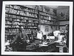 Harry Hoe and Ned Wilson behind the counter of the Kenwood Mercantile Company