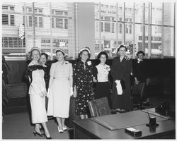 Women posing for a photograph in the American Trust Company offices