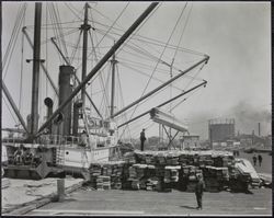Unloading lumber at the Powell Street dock, 41 The Embarcadero, San Francisco, California, 1920s