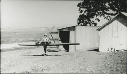 George P. McNear and his sculling craft, Petaluma River, California, about 1910