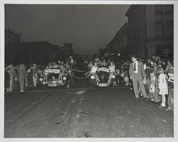 Two cars from Santa Rosa Junior Chamber of Commerce in the 1947 Admissions Day Parade in Santa Rosa, California containing girls in bathing suits--The "Live Wires."