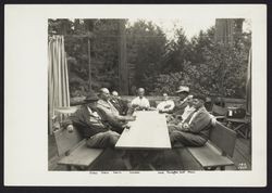 Men sitting around a table at Bohemian Grove