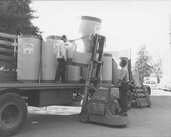 Unloading rolls of newsprint at the Petaluma Argus-Courier, Petaluma, California, about 1955