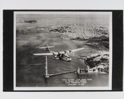 China clipper over south tower of Golden Gate Bridge first westbound flight, November 22, 1935