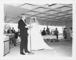 Wedding dress modeled in a fashion show at dedication of parking garage at 3rd and D, Santa Rosa, California, 1964