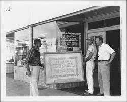 Putting up a Petaluma Centennial sign at Morwear Paint Store, Petaluma, California, 1958