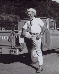 Anton "Tony" G. Brazil in western apparel stands by his truck in Petaluma, California, in the 1960s