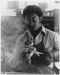 Foundry worker holding a pair of brass California quail water faucet sets ready for machining, likely at the Sebastopol Foundry, 7459 Occidental Road, Sebastopol, California, 1970s or 1980s