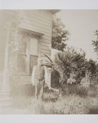 Albert Corliss standing in the yard of his residence, Petaluma, California, about 1910