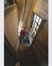 John Agnew walking down the stairs at the Sunset Line & Twine Company building in Petaluma, California, on his last day, Dec. 22, 2006