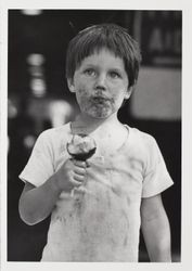 Unidentified boy with his candied apple at the Sonoma County Fair, Santa Rosa, California, 1984