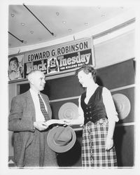 Jo Ann Swan giving a polio drive check to William Turner, Petaluma, California, 1955