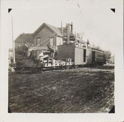 Men aboard a railroad maintenance car outside the Analy Hotel