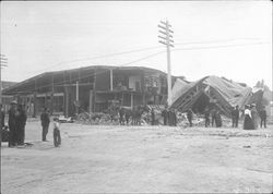 People looking at ruins of a building