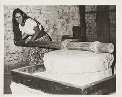 Linda Margarain performs many chores at the Petaluma Adobe, including spinning, grinding corn, candlemaking, baking, etc, Petaluma, California, 1977