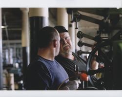 Russell Strickland and "Big" Dennis Henderson standing next to a braider machine on the first floor of the Sunset Line & Twine Company building in Petaluma, California, Dec. 2006