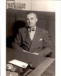 Nathan C. Thompson, Sr. seated at a desk, Petaluma, California, about 1950