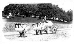 Four boys dressed like chickens pulling an egg float on Main Street near Hill Plaza Park, Petaluma, California, about 1923