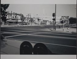 Quake-damaged buildings overlooking debris in Santa Rosa parking lot, Third Street and Mendocino Avenue, Santa Rosa, California, September 1969