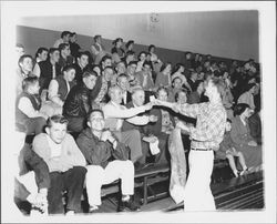 Bob McConnell selling peanuts for the Block P group at a basketball game, Petaluma, California, 1955