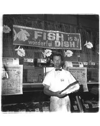 Bruce Coleman in front of the meat counter at Purity Grocery Store, Petaluma, California, 1955