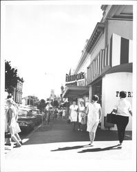 People on sidewalk in front of Denton's Apparel & Baby Furniture, Petaluma, California, 1958