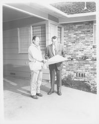 Lewis Meyers and unidentified man inspecting a Meyers built home, Santa Rosa, California, 1960