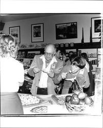 George and Marilyn Mertens sampling cheese at the 50th anniversary party at Sonoma Cheese Factory, Sonoma, California, 1981