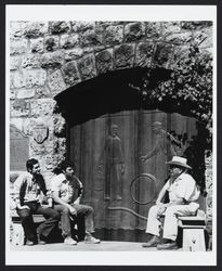 Sam, Don and father August Sebastiani sit beside the newly carved main doors at Sebastiani Vineyards