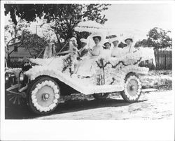 Women in car decorated for Rose Parade