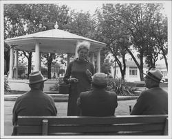 Helen Putnam speaking with three men in Walnut Park, Petaluma, California, 1967