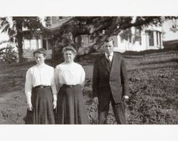 Louise McNear and George P. McNear, Jr pose with their mother Ida Belle McNear in the yard at "Belleview," the McNear home in Petaluma, California, about 1910