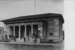 Men standing on steps of post office